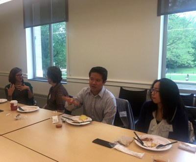 Graduate student Maria Maza engages in discussion with participant Ben Bascom as Rob Nguyen and Yi-Ting Chang talk to participants over BBQ.